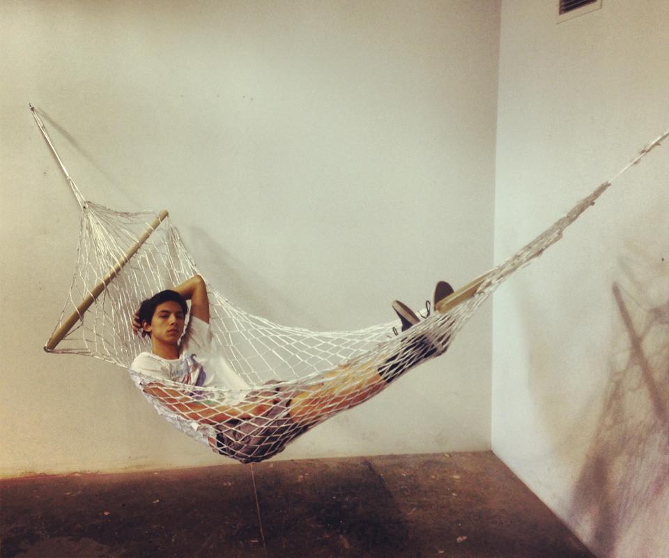 “Hammock” – (made from plastic bags, the artist is seen using the finished piece in this photo)